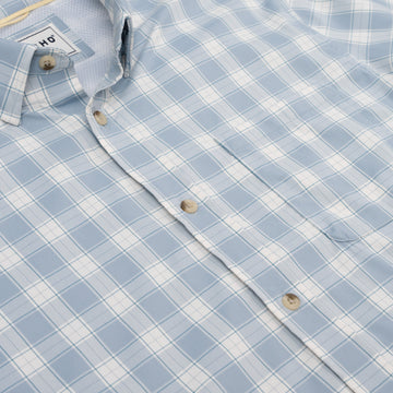 Close up of chest pocket on blue plaid button down shirt