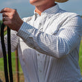 Picture of man wearing striped western shirt holding reins