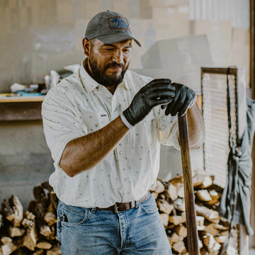 man holding wooden pole
