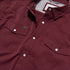 closeup chest maroon pearl snap shirt