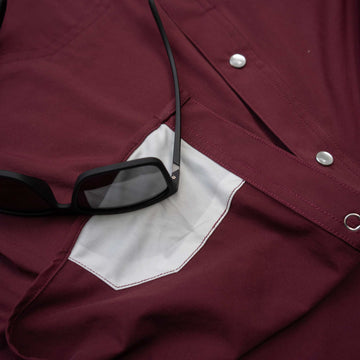 closeup lens cloth on maroon pearl snap shirt