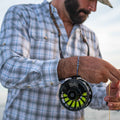 man fishing while wearing grey / blue plaid long sleeve shirt