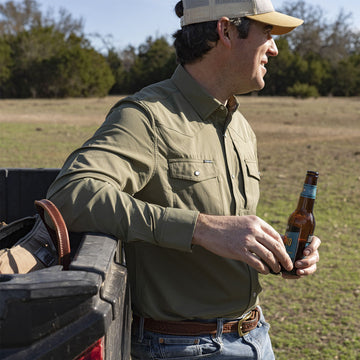 Long sleeve green western shirt man with beer by truck