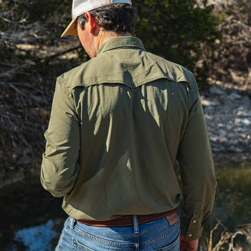 Man facing away from camera wearing green long sleeve shirt