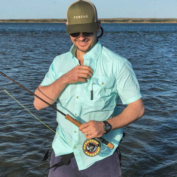 Aqua green shirt short sleeve man with fishing gear