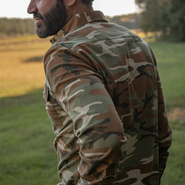 Man modeling camo flannel shirt