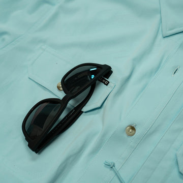 Aqua green shirt long sleeve sunglass close up