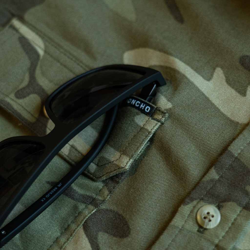 Close up of camo shirt with sunglasses