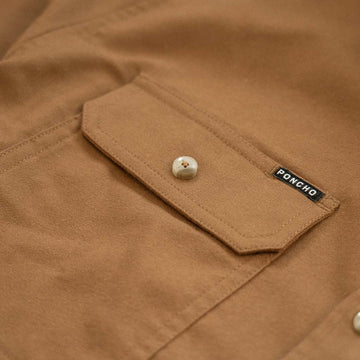 Poncho logo on pocket of flannel shirt