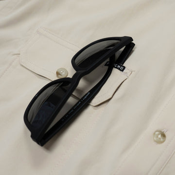 tan shirt sunglass close up