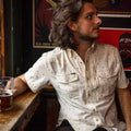 Photo of man holding a glass wearing the floral western short sleeve shirt