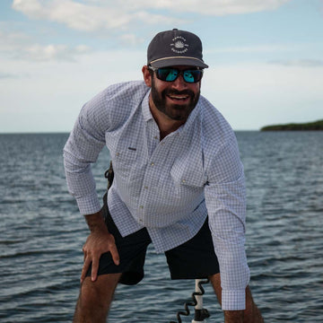 Navy Hat with Poncho logo - Man on boat