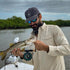 Man fishing on boat in Navy hat