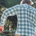 back of guy with fishing rod in hand