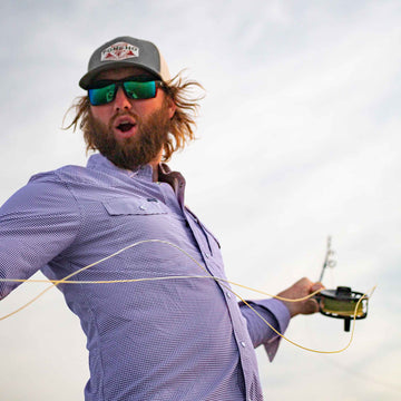 fisherman wearing purple microcheck long sleeve western pearl snap shirt