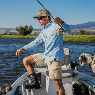 Man in blue shirt fishing