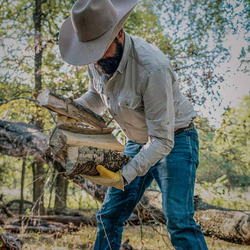 Man carring wood in grey shirt