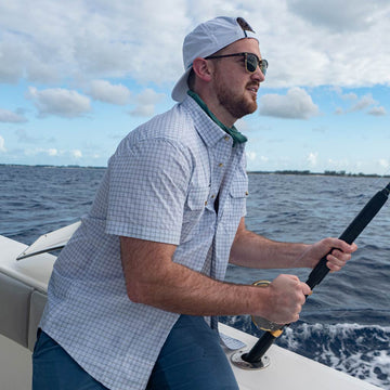 Blue & grey plaid short sleeve fishing shirt - man fishing