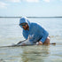 man holding fish wearing sky blue hoodie
