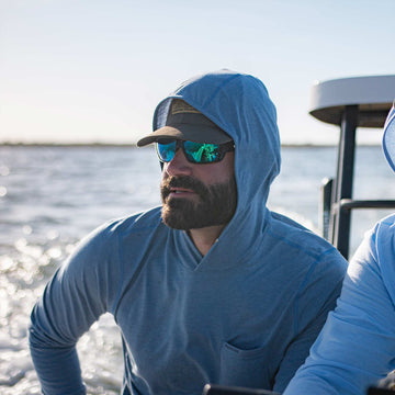 man on boat wearing slate blue hoodie
