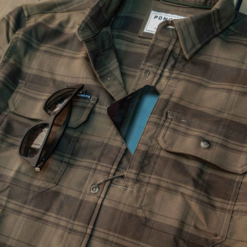 closeup of shades and phone in zip pocket on shirt