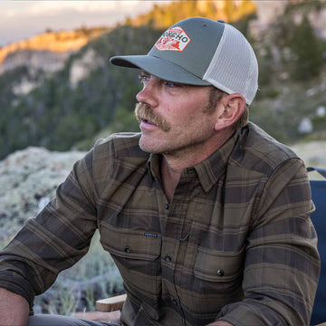 guy wearing flannel sitting outside