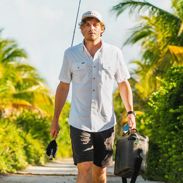 Man in white shirt with fishing gear