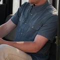 Man wearing short sleeve blue shirt