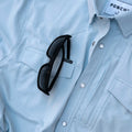sunglasses on light blue short sleeve pearl snap shirt
