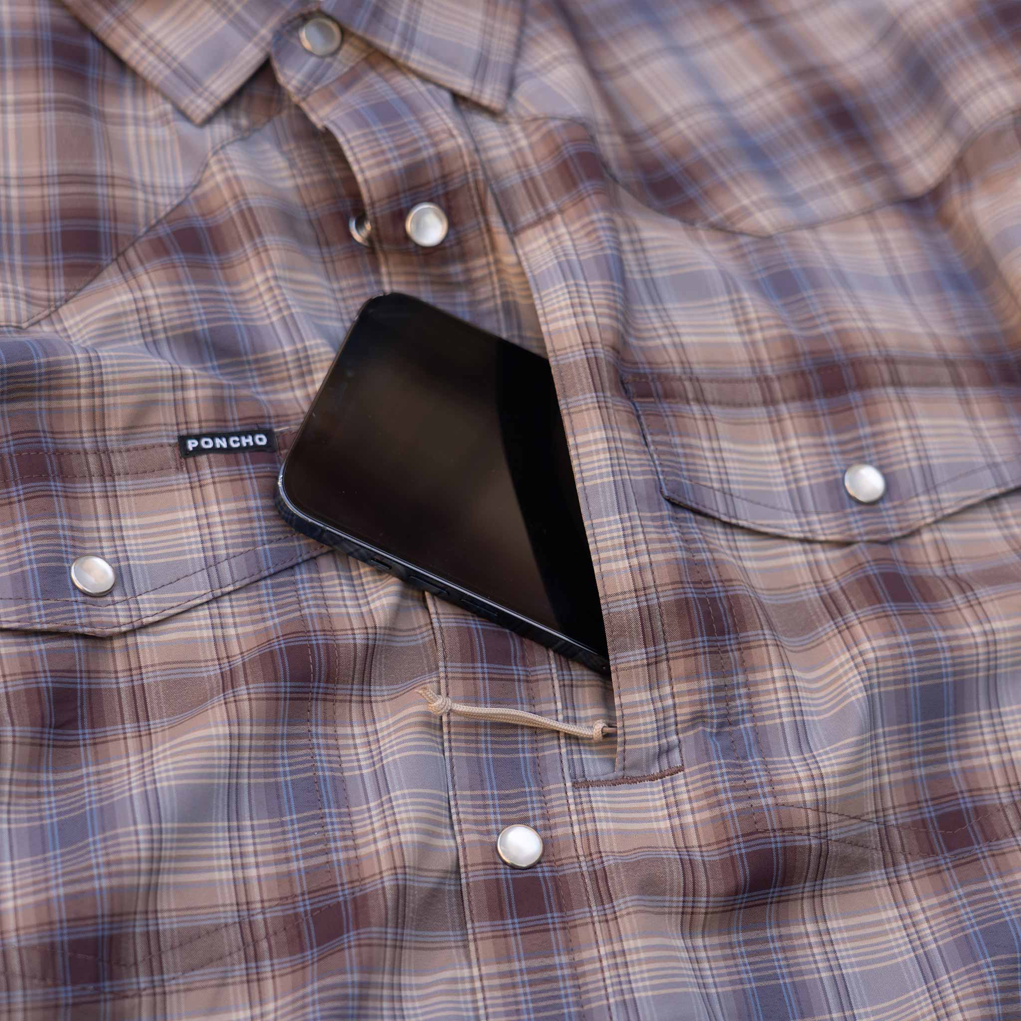 closeup of phone in chest zip pocket on shirt