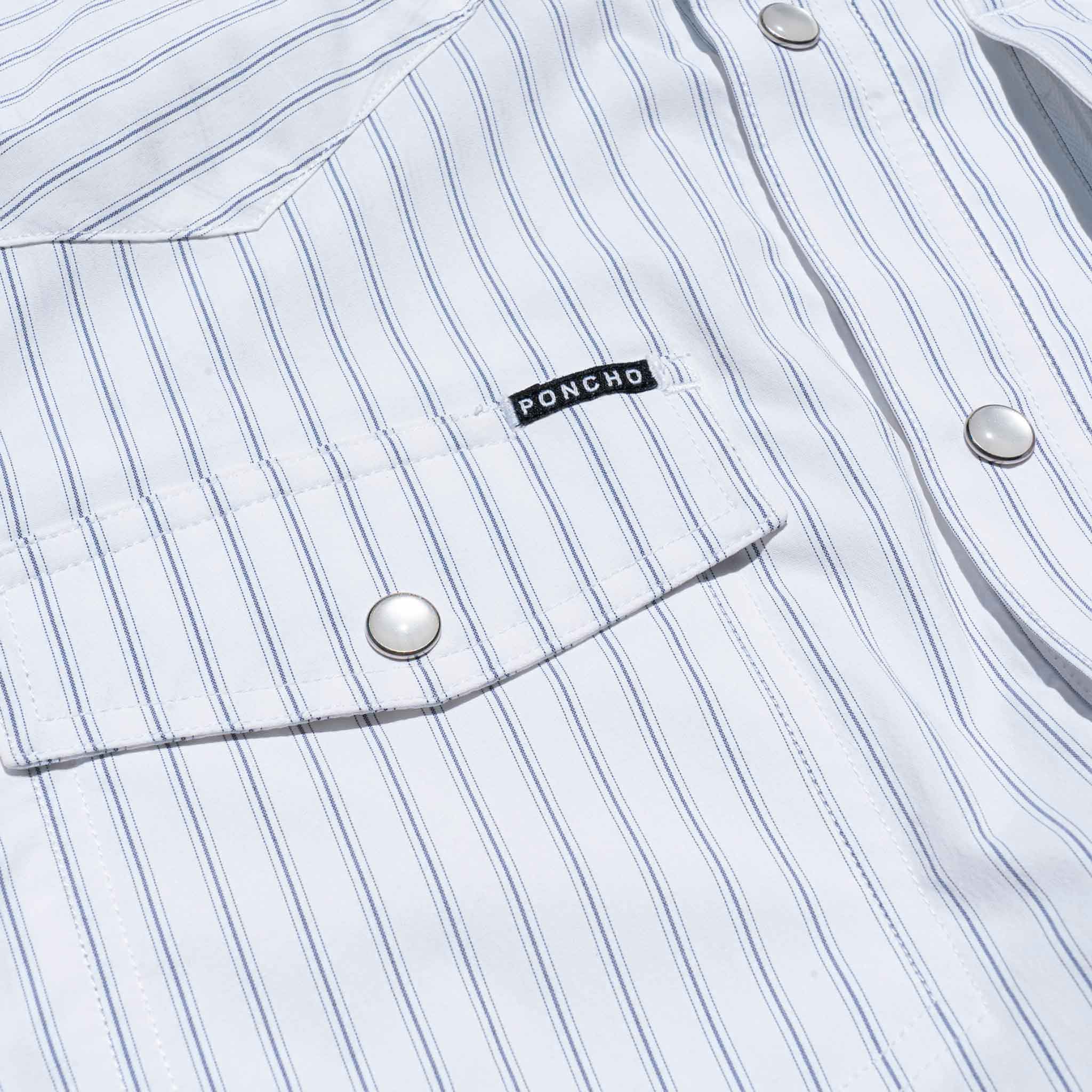 Close up of pocket of striped shirt with pearl snaps