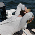 man on boat with hands on his head