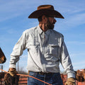cowboy handling horse, wearing shirt