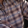 close up of brown blue plaid shirt