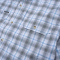 Close up of short sleeve blue and grey plaid shirt