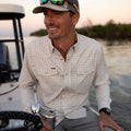 man wearing shirt on boat smiling
