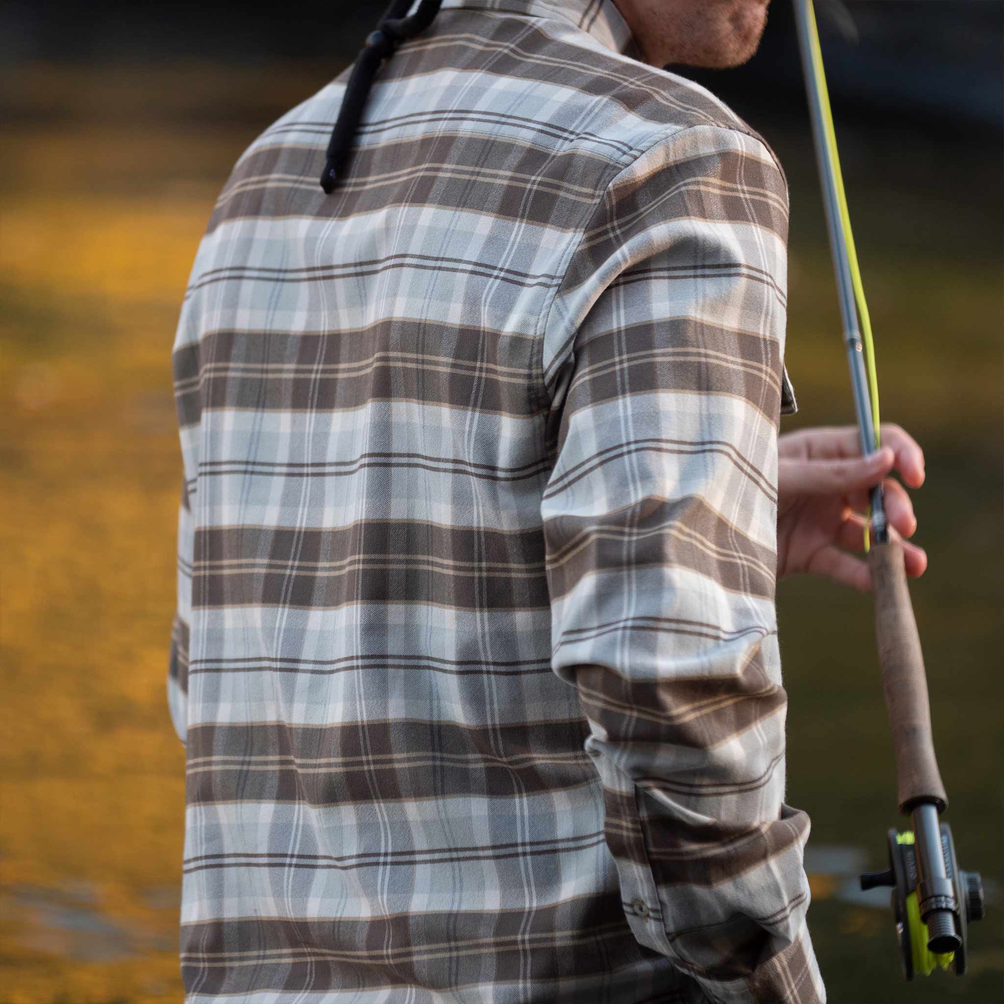 back view of fisherman wearing brown and grey plaid long sleeve flannel