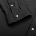 closeup cuff of black long sleeve pearl snap shirt 