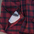 lens cloth on bottom of red plaid shirt