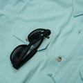 Aqua green shirt short sleeve sunglasses close up