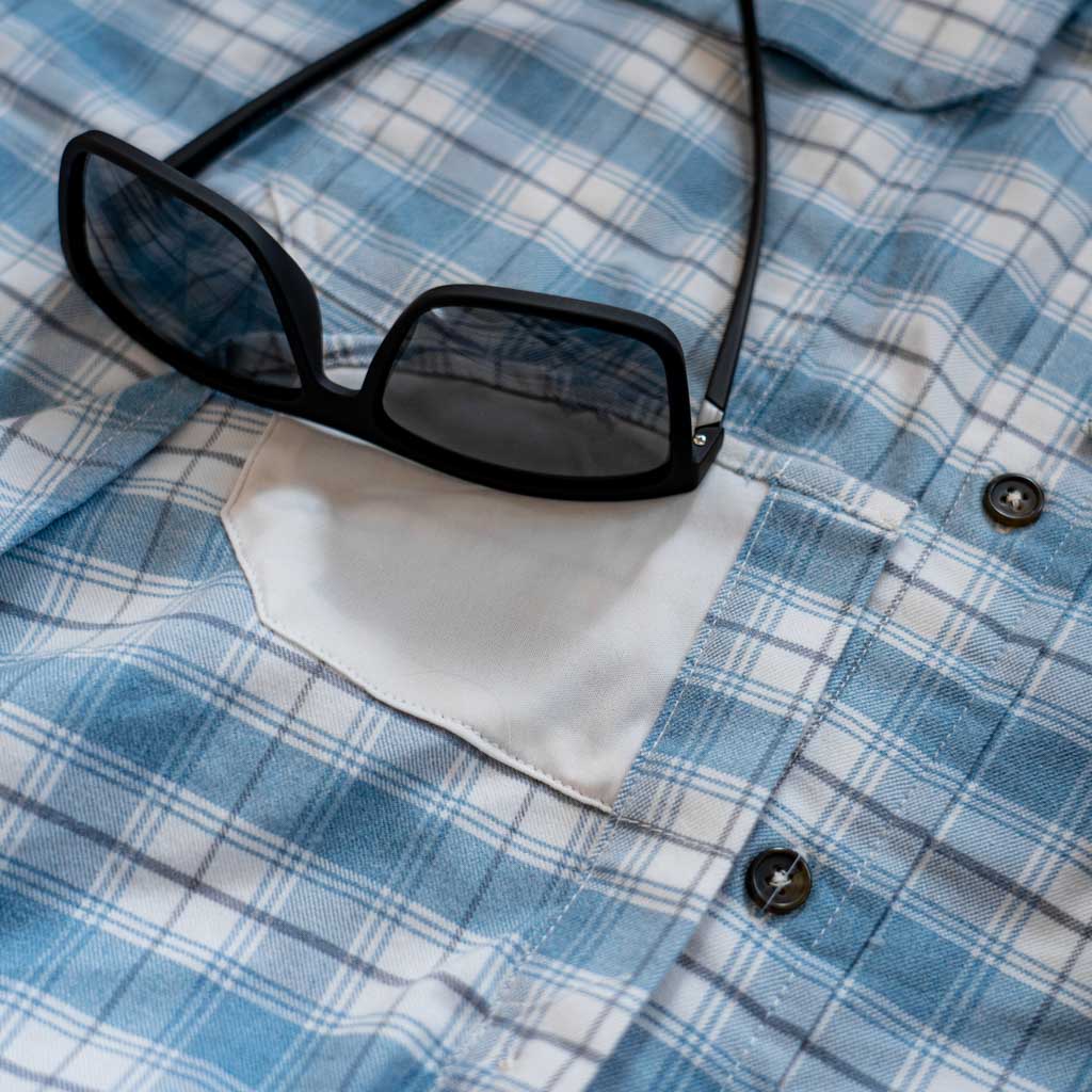 Photo showing eyeglass cleaner built into shirt, with sunglasses 
