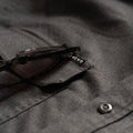 close up photo of sunglasses holder on shirt pocket