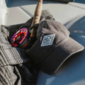 lifestyle pic of hat with fishing rod