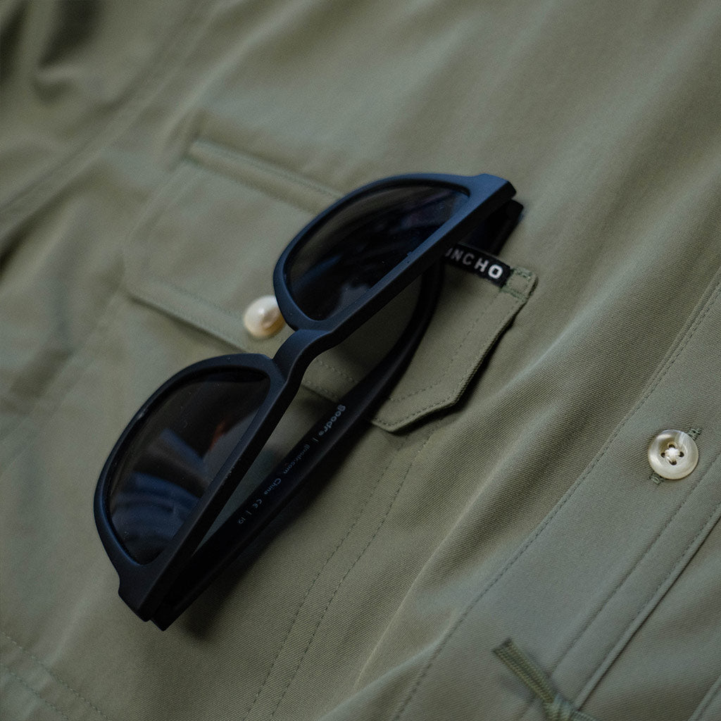 sunglasses on slit on shirt