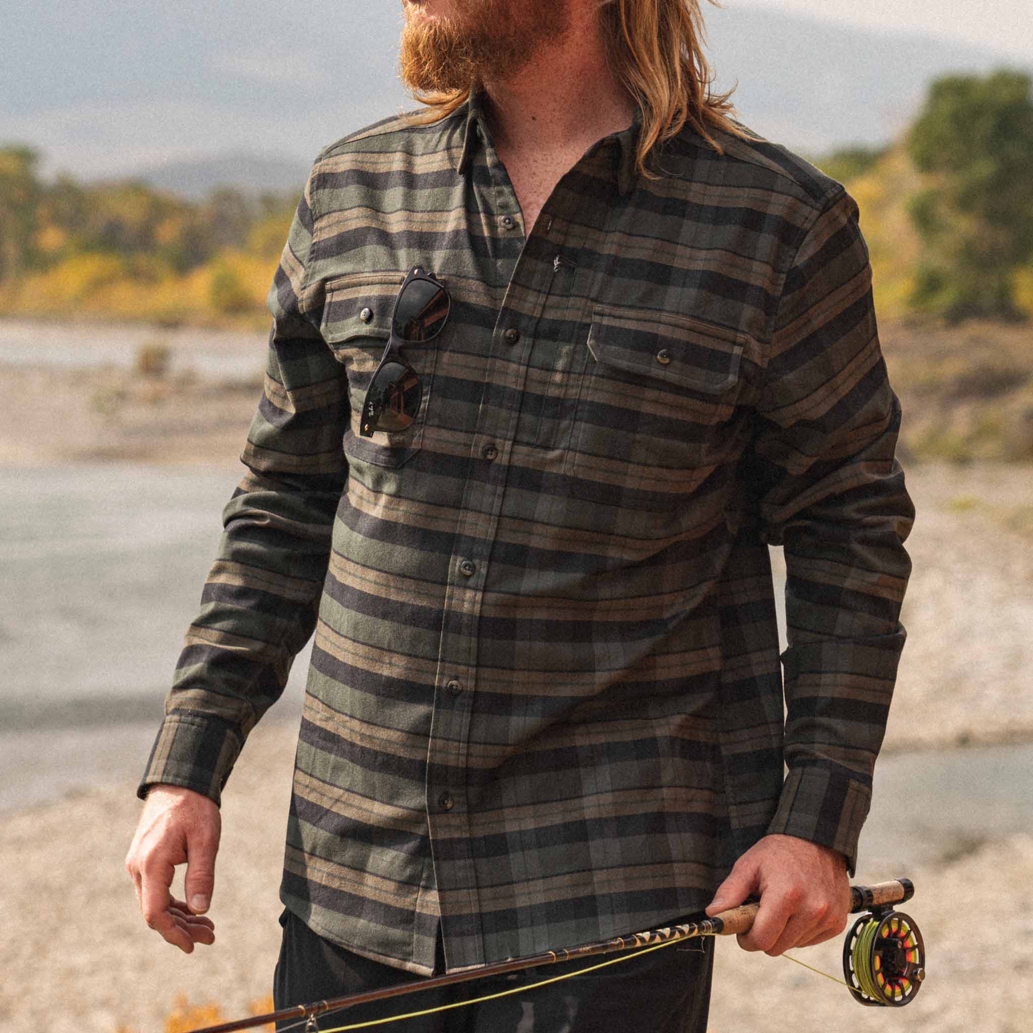 Man with fishing rod wearing the Kodiak plaid flannel