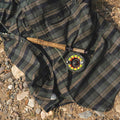 Image of a fishing rod on top of the Kodiak plaid flannel