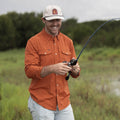 Photo of man fishing in the burnt orange long sleeve shirt