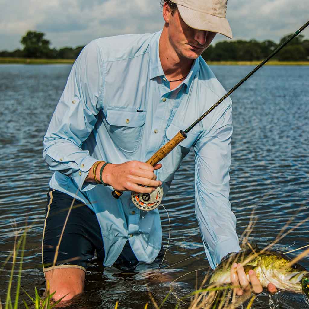 Man in blue shirt with fishing gear