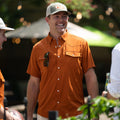 Colt McCoy wearing short sleeve burnt orange shirt with pearl snaps