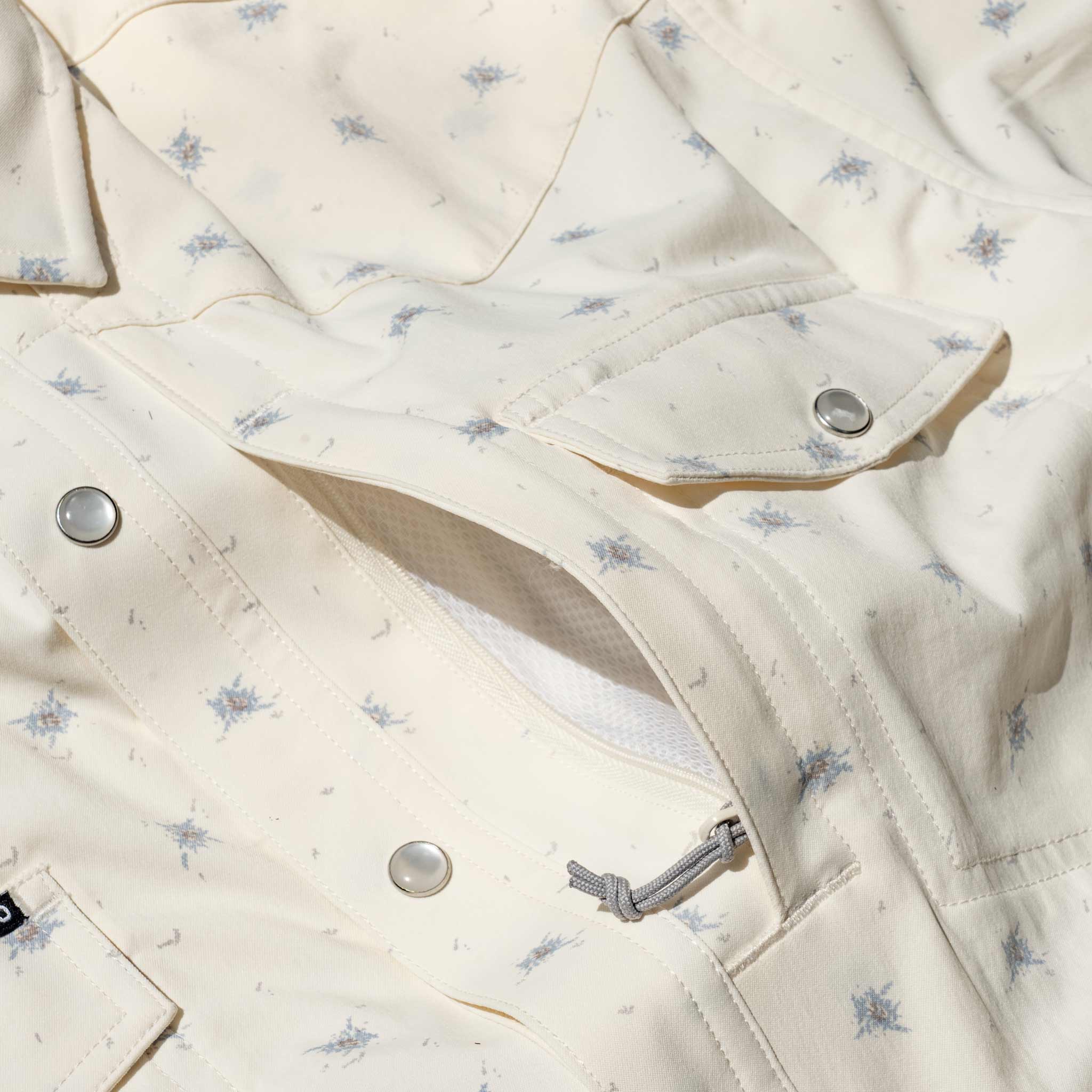 Closeup of floral shirt front pockets.